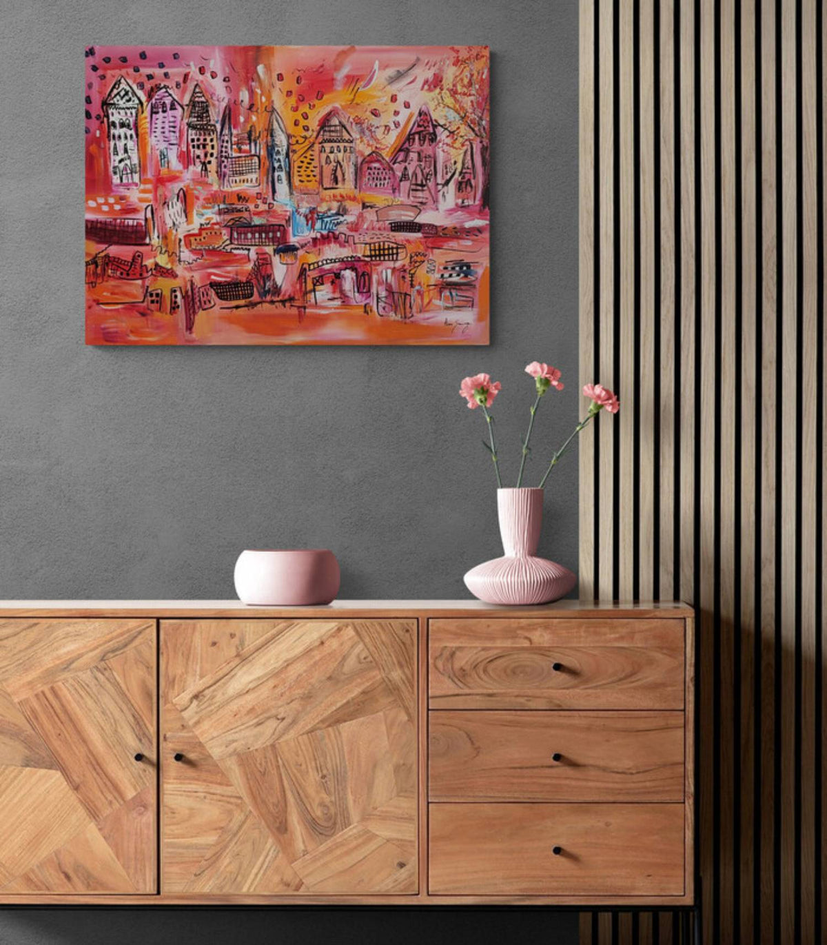Orange city abstract painting displayed above a modern living room sideboard